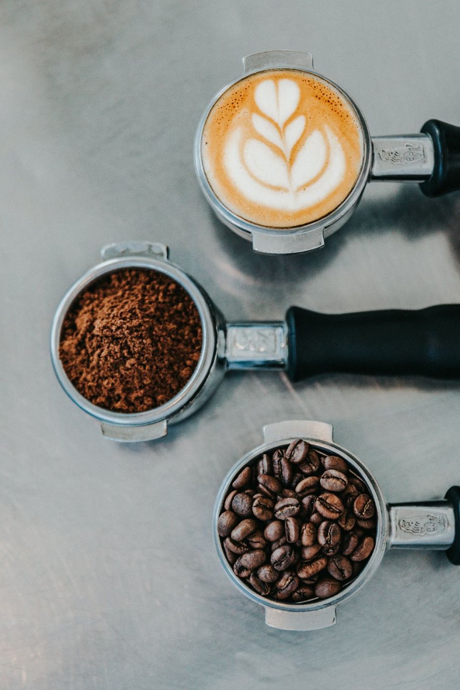 Coffee beans beside a cappuccino