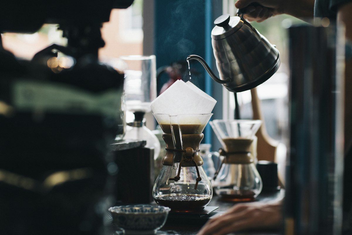 Hot water being poured into a glass pour-over coffee maker