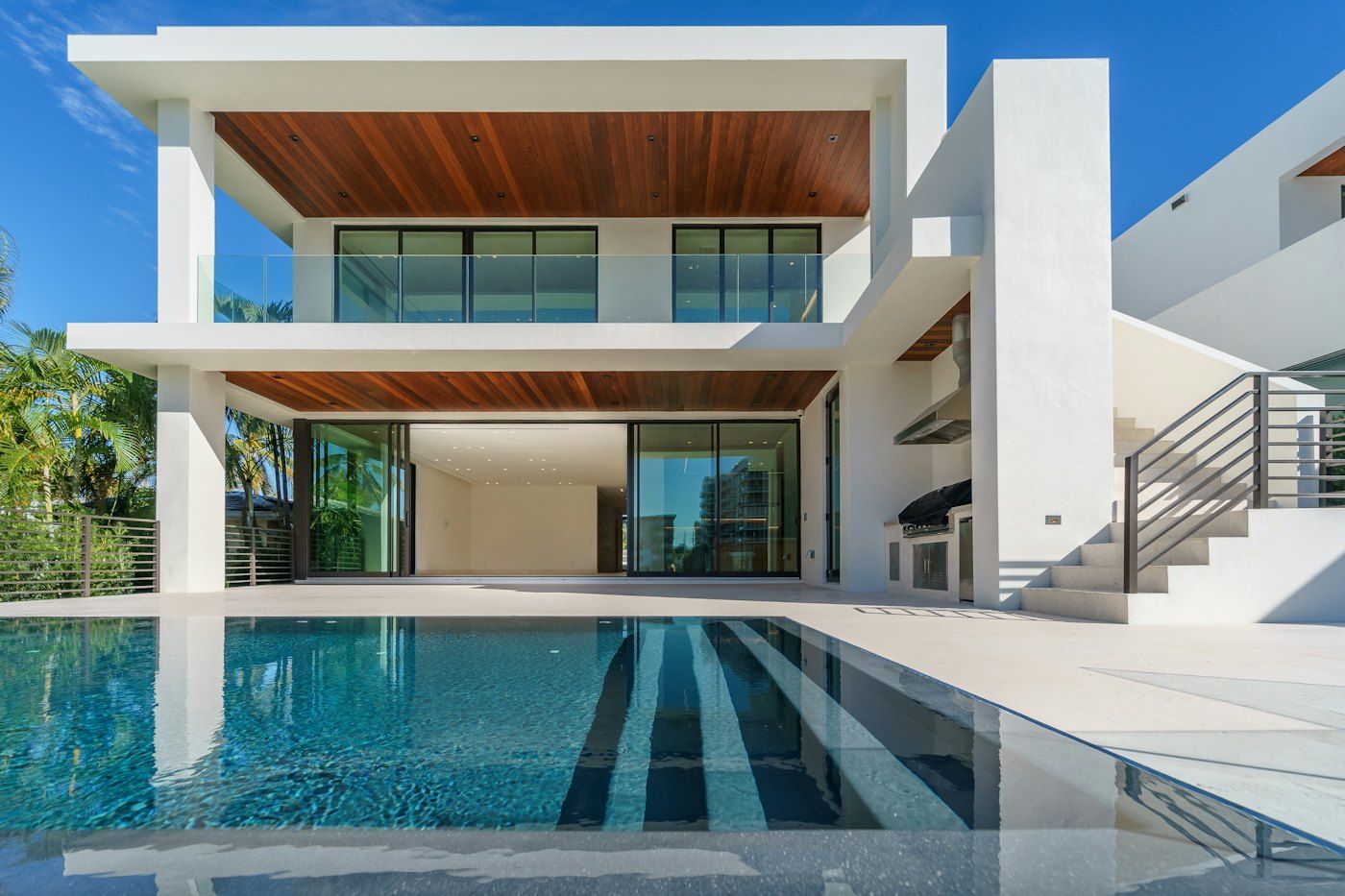 Modern white home with a clear rectangular pool